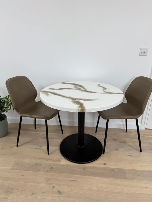 Handmade round epoxy resin dining table with 3.6 cm thick top and cast iron pedestal base – made to order in the UK.