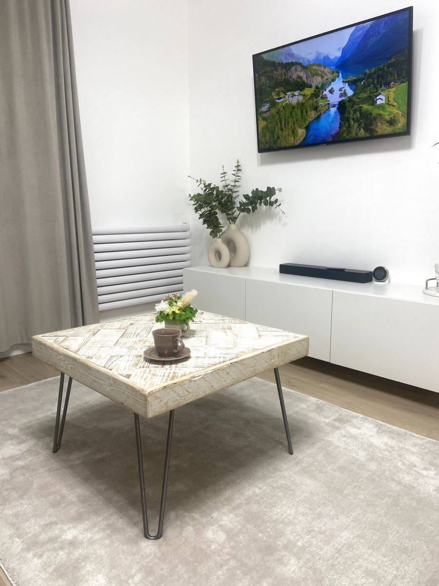 Handmade double herringbone coffee table with distressed reclaimed wood top and metal legs – rustic and bold living room centerpiece