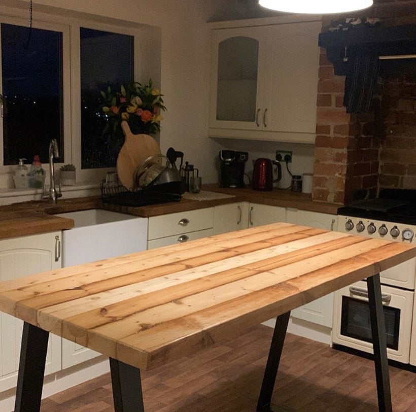 Handcrafted reclaimed wood breakfast bar made from aged joists, featuring natural imperfections, a smooth wax finish, and 90cm high industrial metal legs