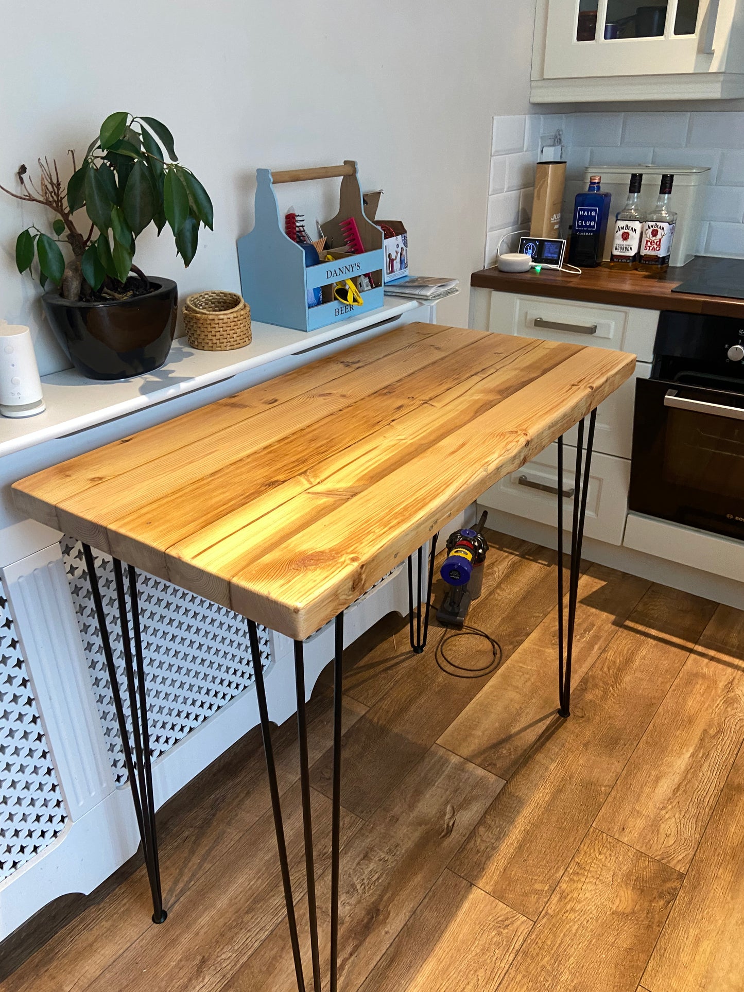 Handcrafted reclaimed wood breakfast bar made from aged joists, featuring natural imperfections, a smooth wax finish, and 90cm high industrial metal legs