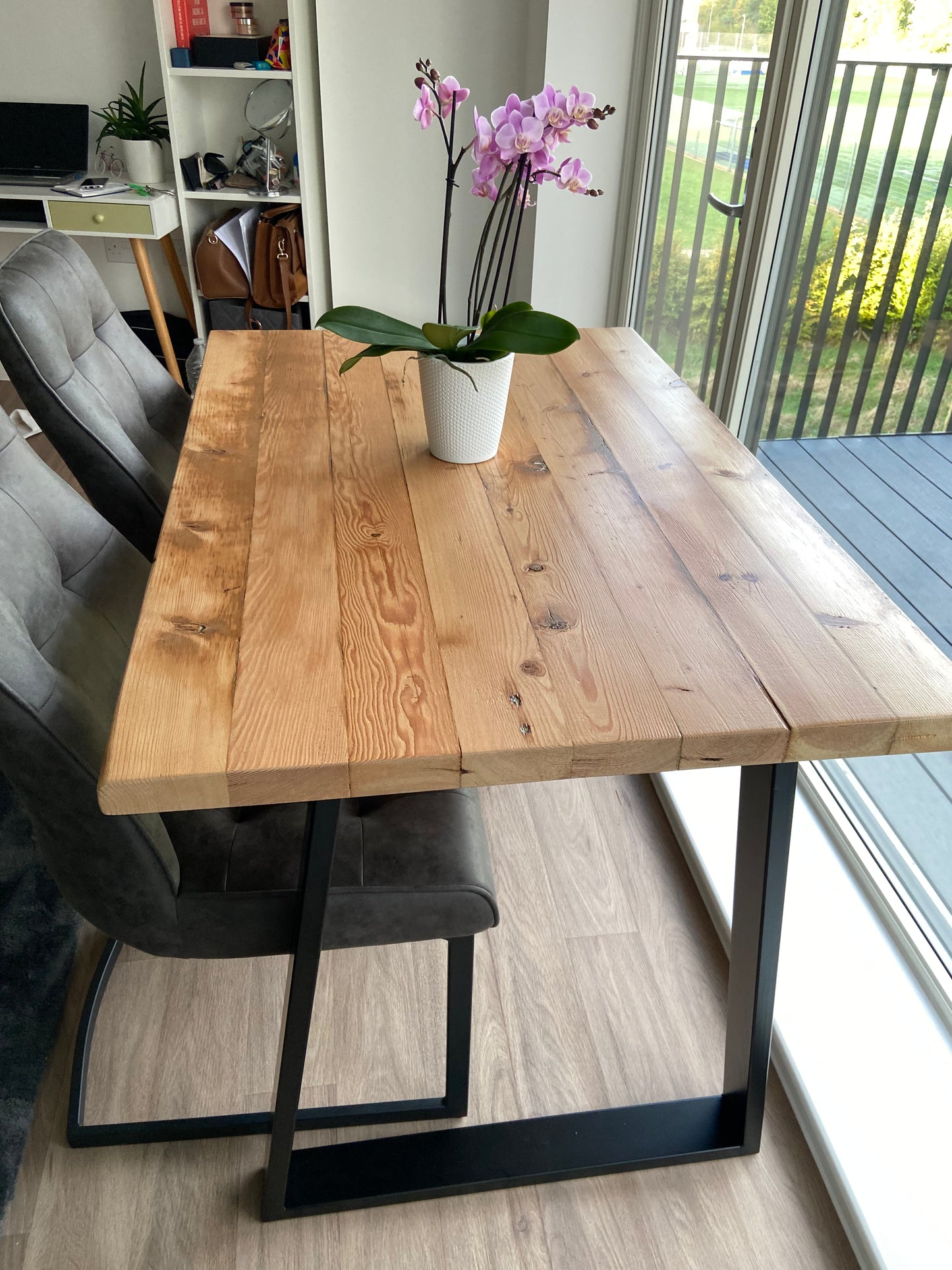 Reclaimed wood dining table with matching benches tucked underneath – rustic industrial style furniture set