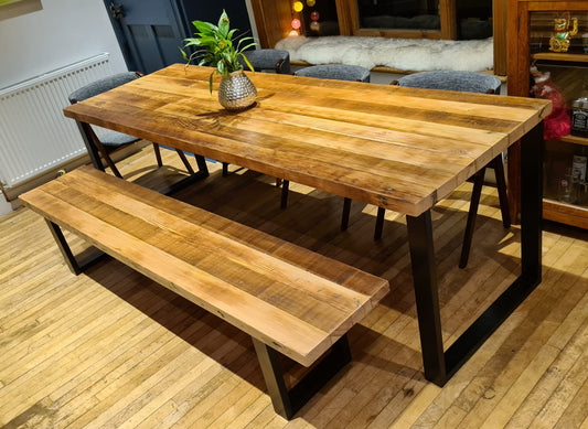 Reclaimed wood dining table with matching benches tucked underneath – rustic industrial style furniture set