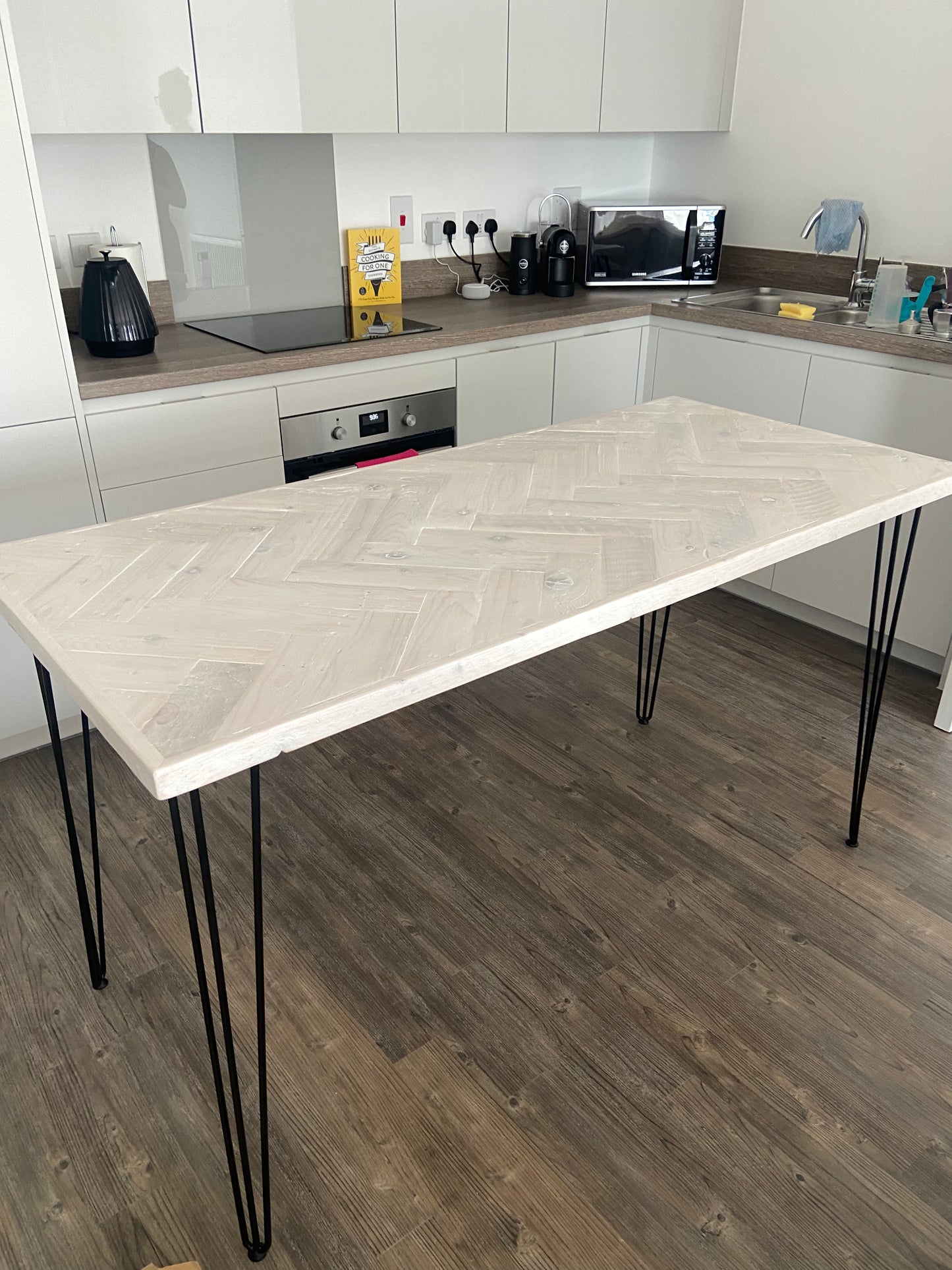 Handmade herringbone breakfast bar crafted from reclaimed wood with custom metal legs, made to order in the UK