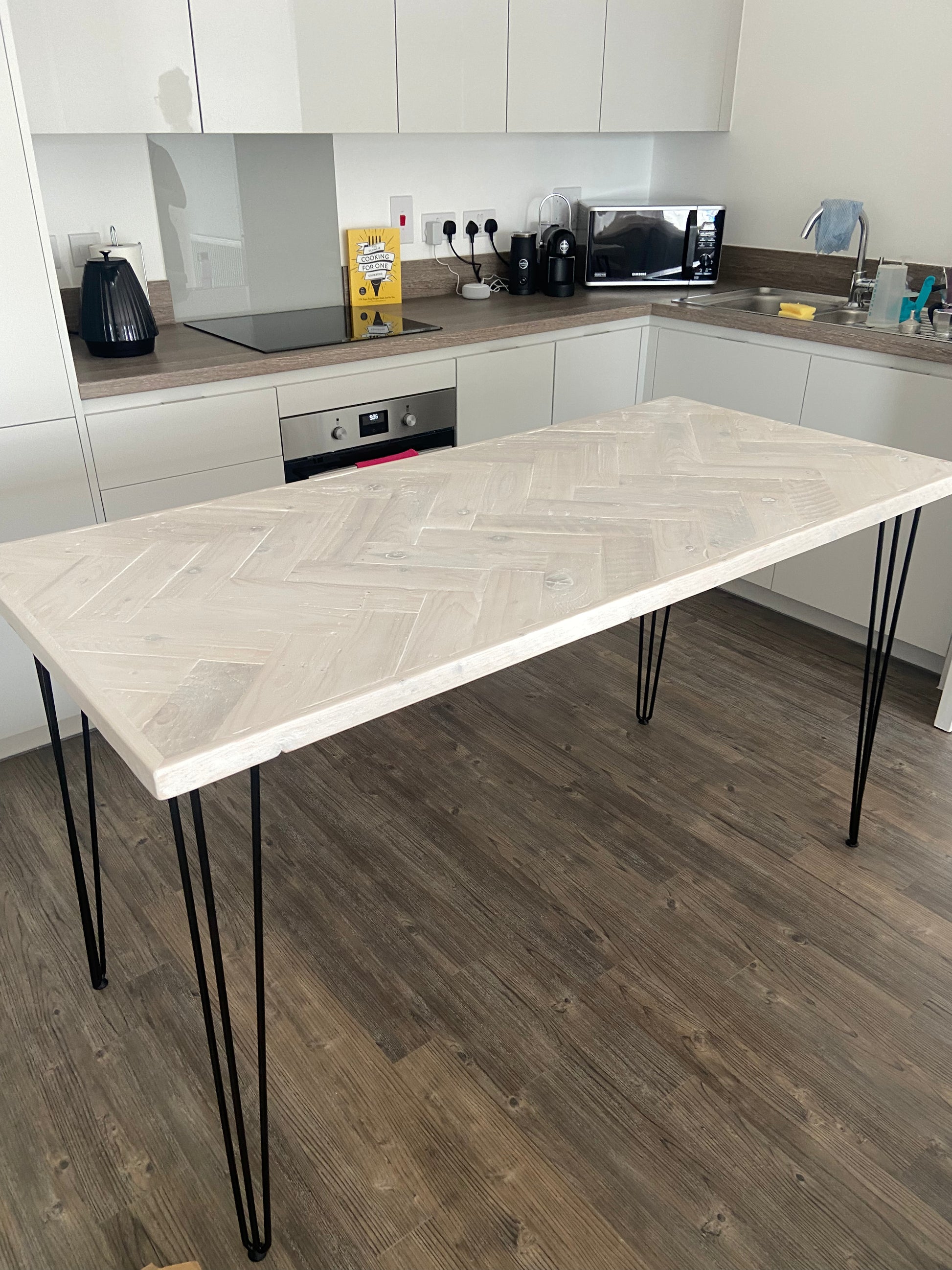 Handmade herringbone breakfast bar crafted from reclaimed wood with custom metal legs, made to order in the UK
