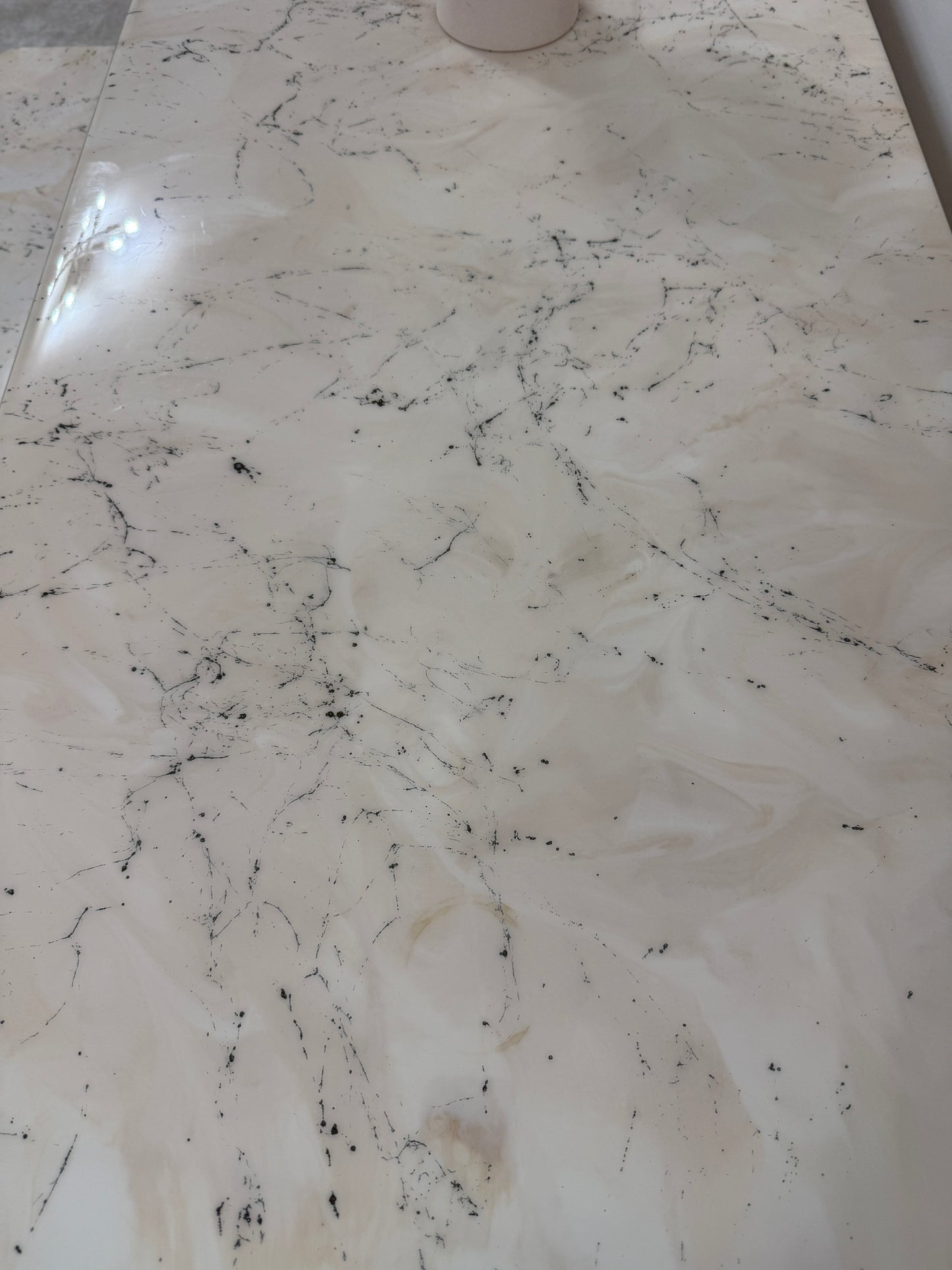 Handmade epoxy resin dining table with artistic marble effect top and custom metal legs – made to order in the UK, optional matching benches available.