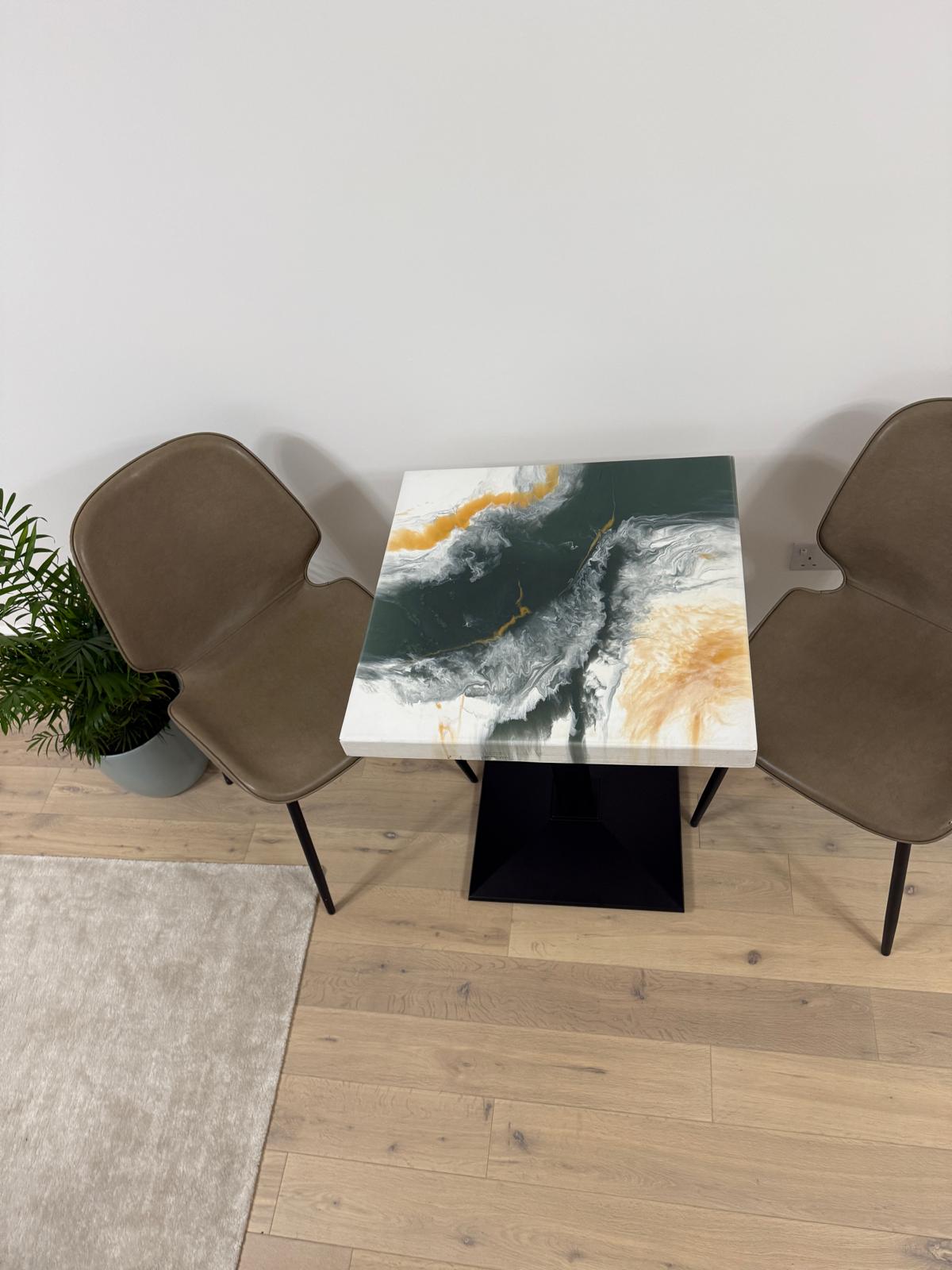 Handmade square epoxy resin dining table with artistic top and cast iron pedestal base – made to order in the UK.