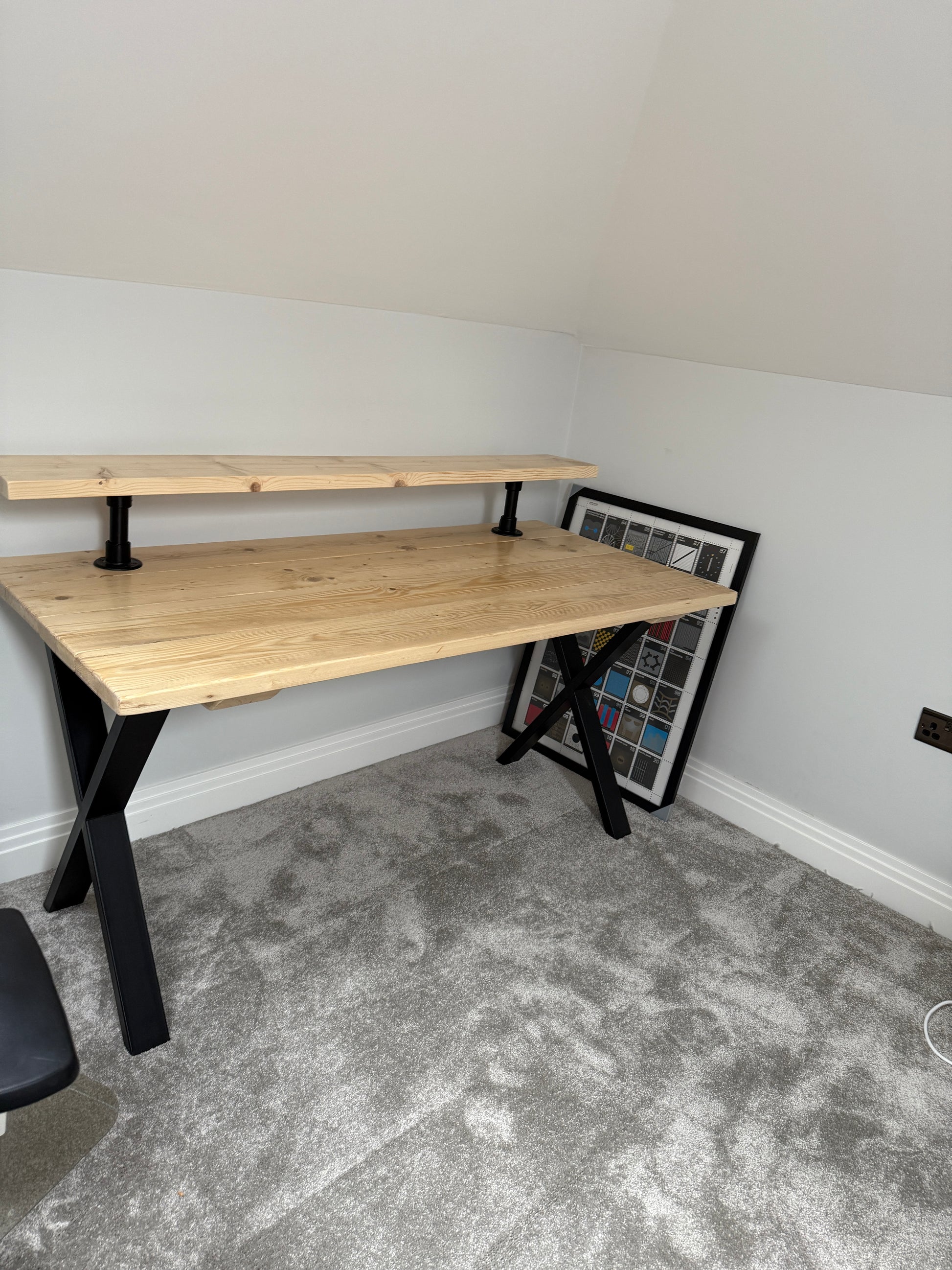 Handmade industrial desk with monitor shelf crafted from reclaimed wood and steel legs – rustic and modern workspace design.