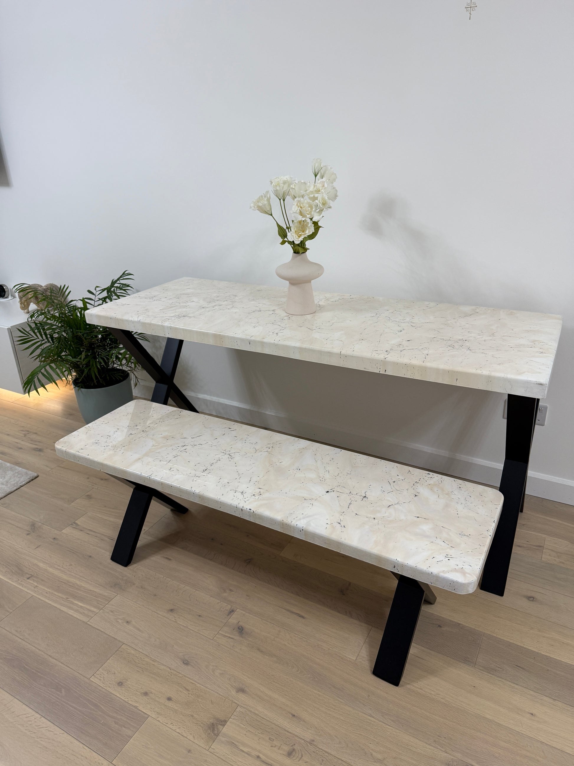 Handmade epoxy resin dining table with artistic marble effect top and custom metal legs – made to order in the UK, optional matching benches available.