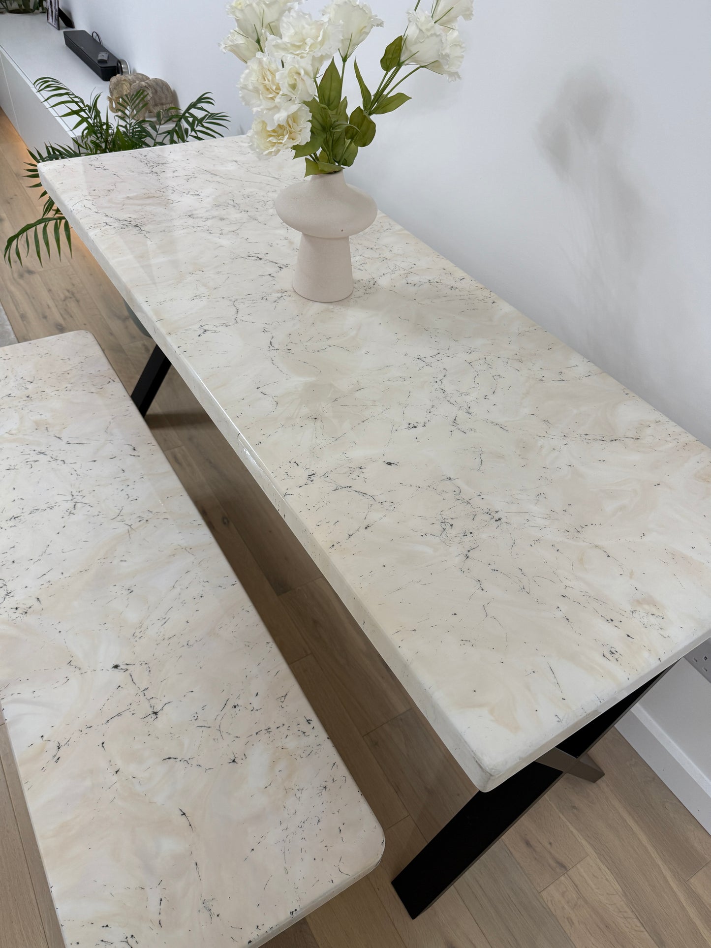 Handmade epoxy resin dining table with artistic marble effect top and custom metal legs – made to order in the UK, optional matching benches available.
