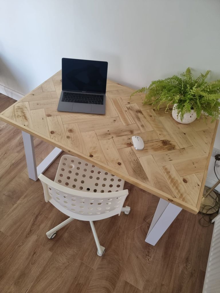Handcrafted desk with double herringbone reclaimed wood top and industrial metal legs – rustic yet modern design for home office or workspace.