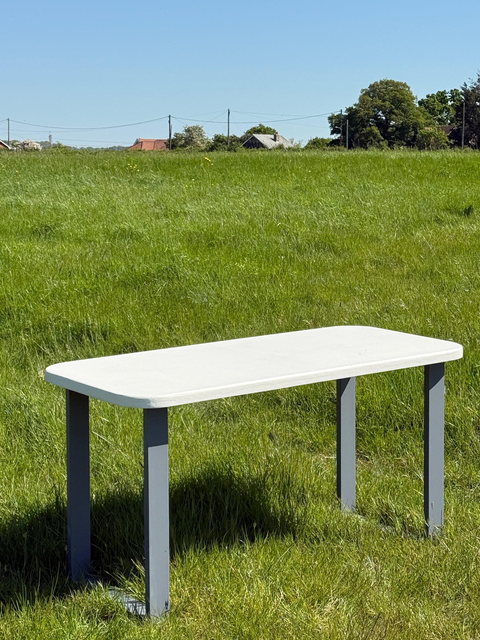 Handmade outdoor microcement dining table with white concrete-style top and matching benches – made to order in the UK, ideal for patios and terraces.