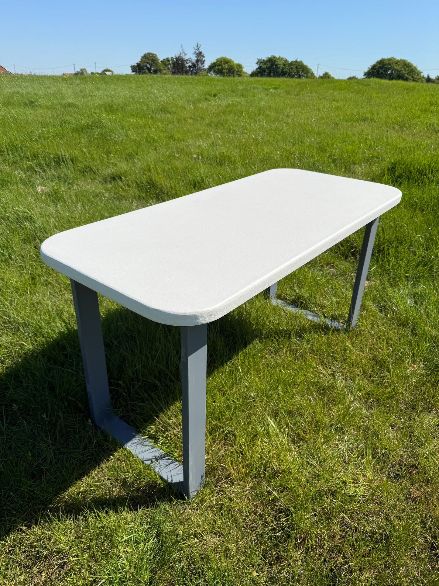 Handmade outdoor microcement dining table with white concrete-style top and matching benches – made to order in the UK, ideal for patios and terraces.