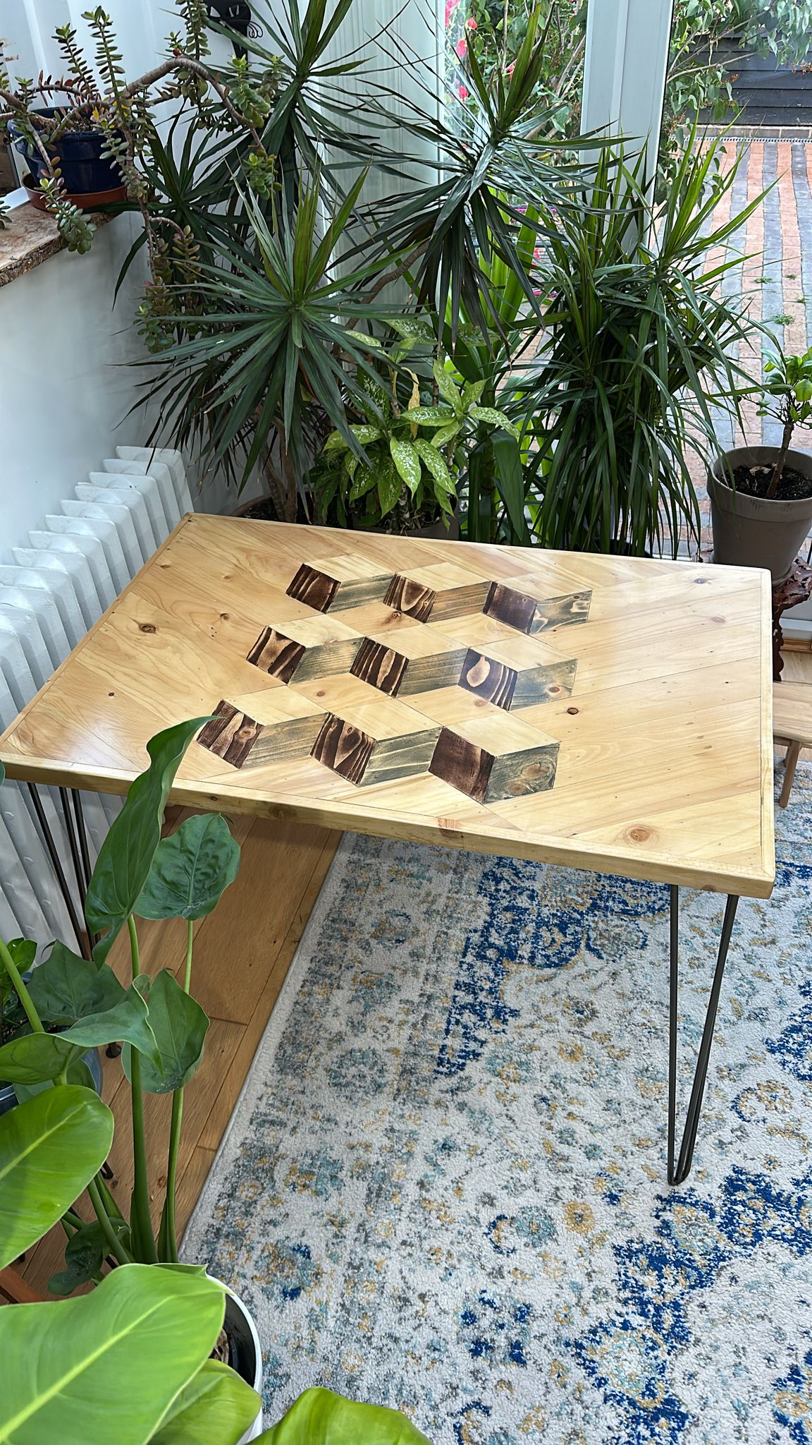 Reclaimed wood dining table with subtle 3D pattern top, handcrafted in the UK, finished with natural wax and showcasing rustic character details