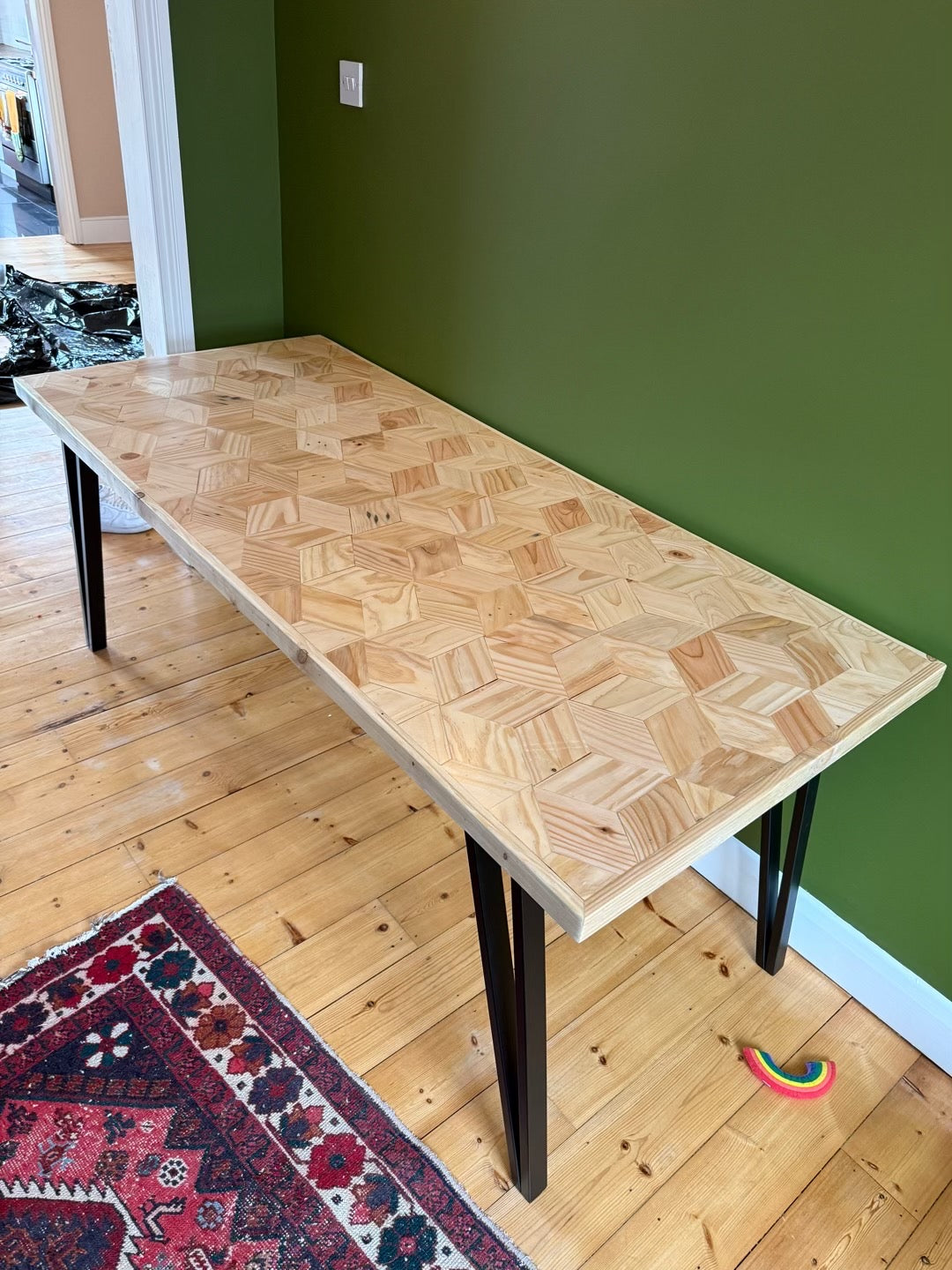 Handcrafted 3D reclaimed wood dining table with unique random pattern top, natural wax finish, and rustic character details like saw marks and paint traces