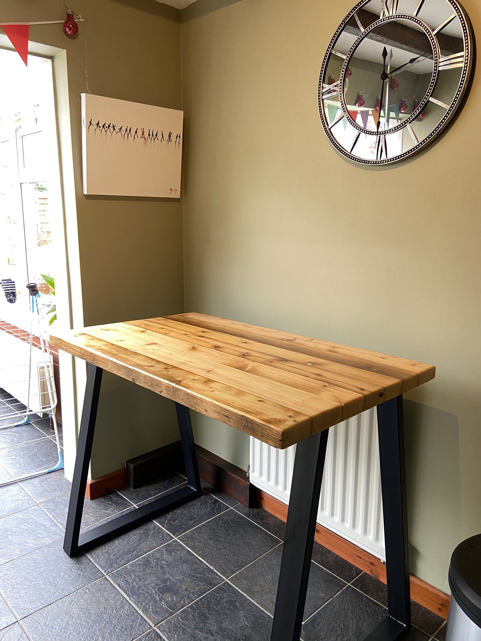 Handcrafted reclaimed wood breakfast bar made from aged joists, featuring natural imperfections, a smooth wax finish, and 90cm high industrial metal legs