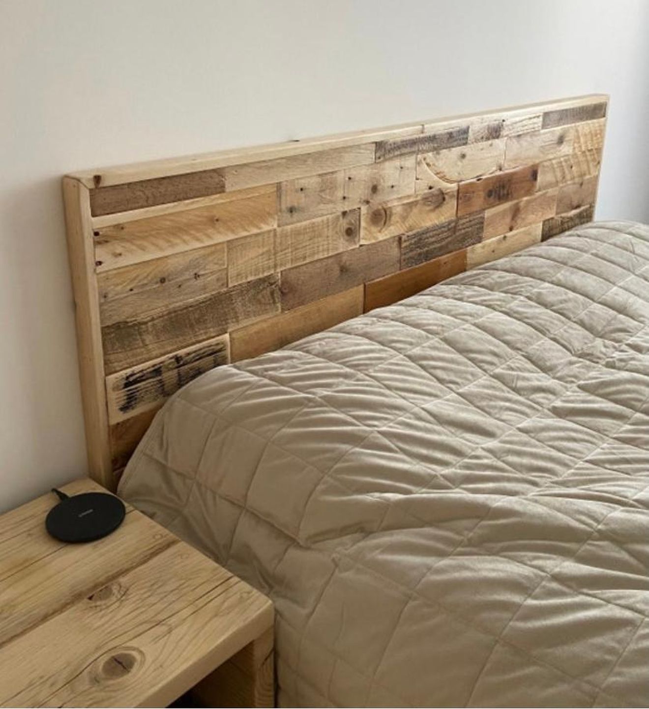 Wall-mounted headboard made from reclaimed wood planks with natural rustic finish – handmade and eco-friendly design