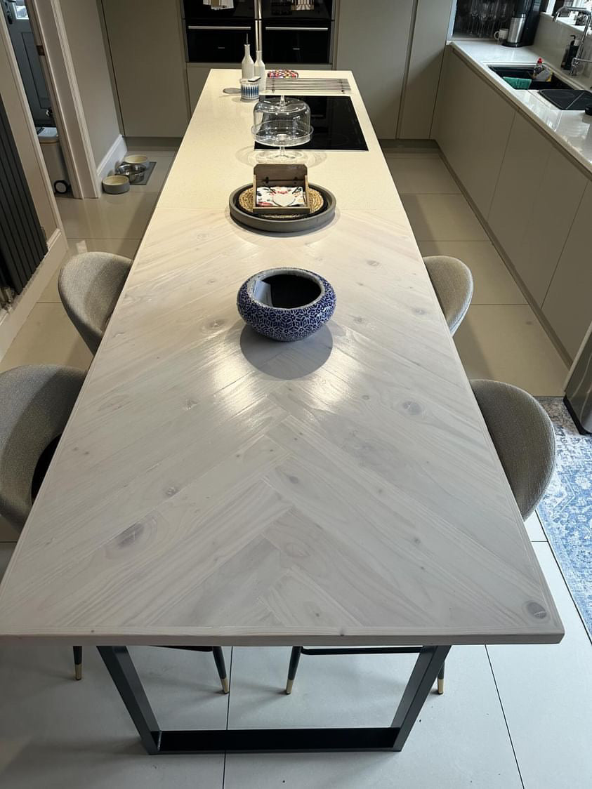 Handmade herringbone breakfast bar crafted from reclaimed wood with custom metal legs, made to order in the UK