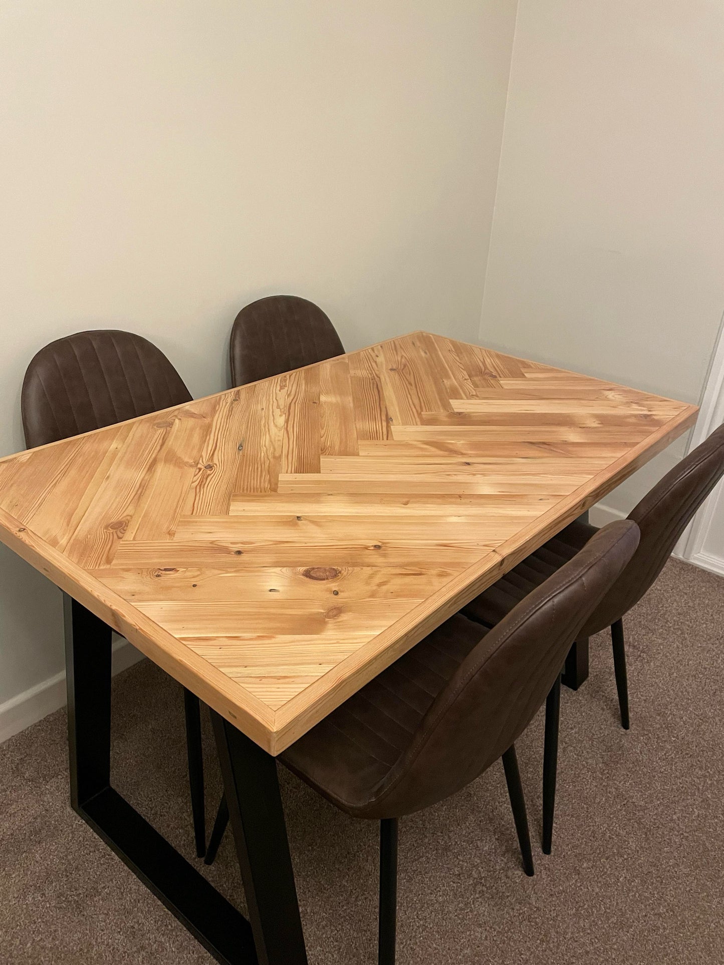 Handmade herringbone table crafted from reclaimed wood with metal legs, made to order in the UK