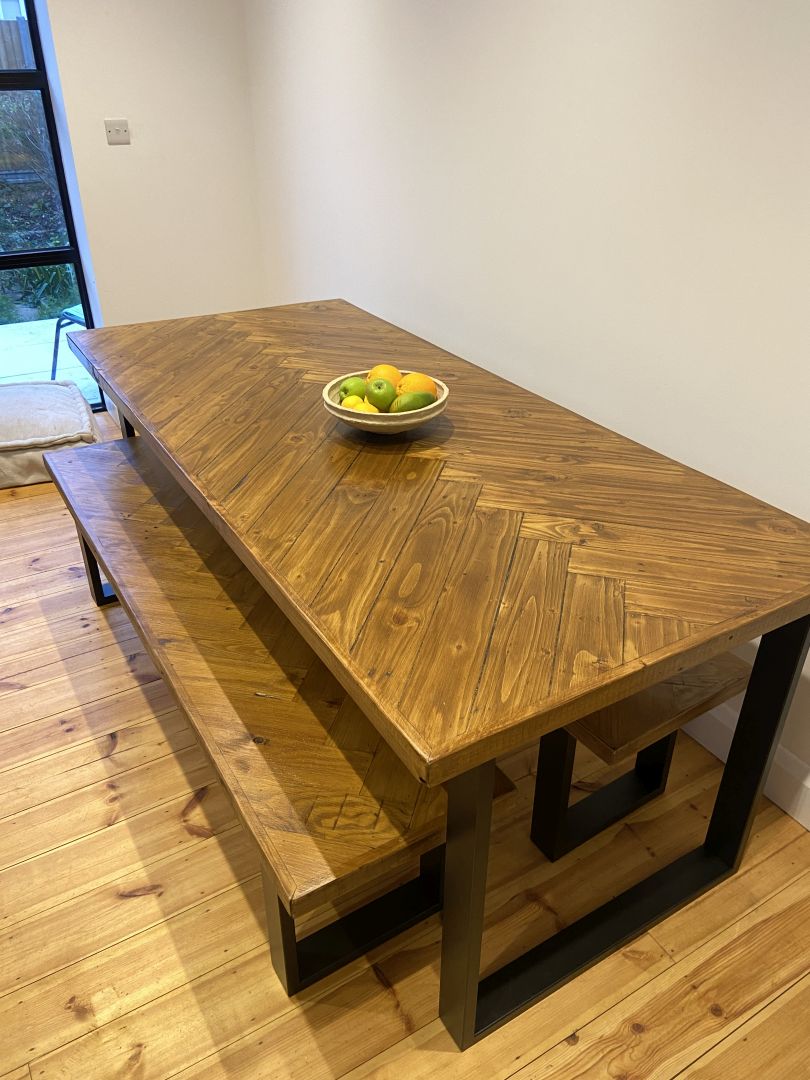 Handcrafted herringbone dining table made from reclaimed wood