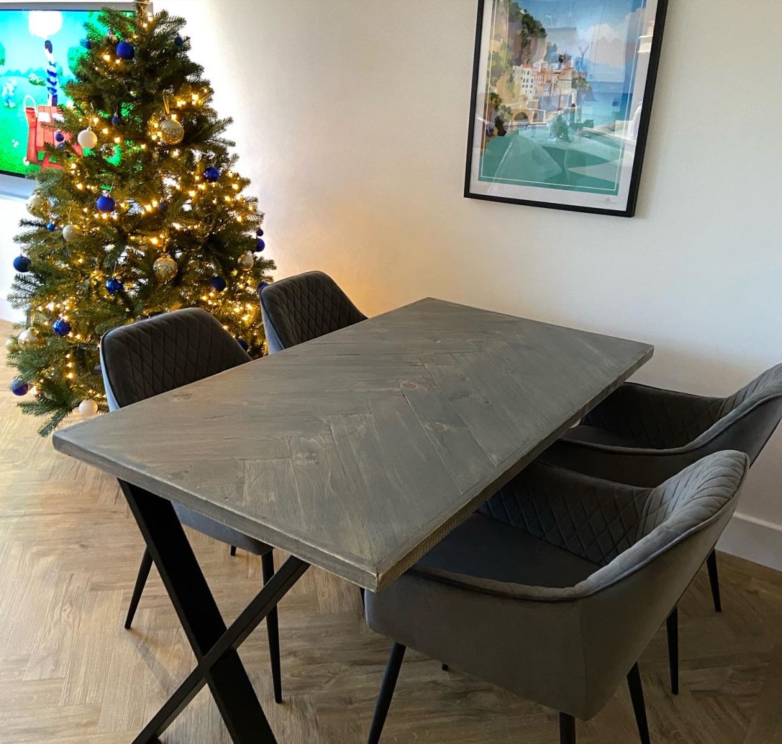 Handcrafted herringbone dining table made from reclaimed wood
