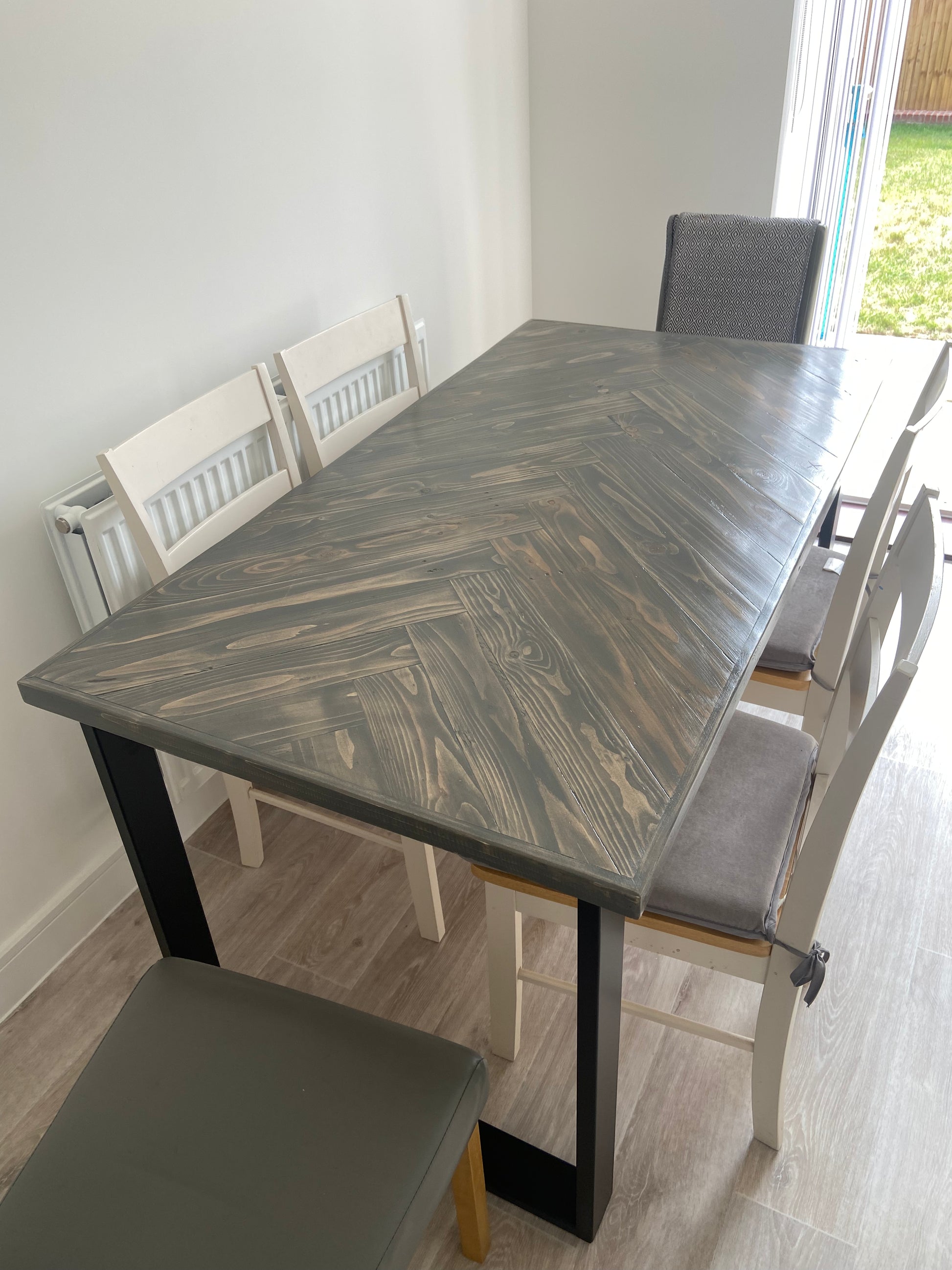 Handcrafted herringbone dining table made from reclaimed wood