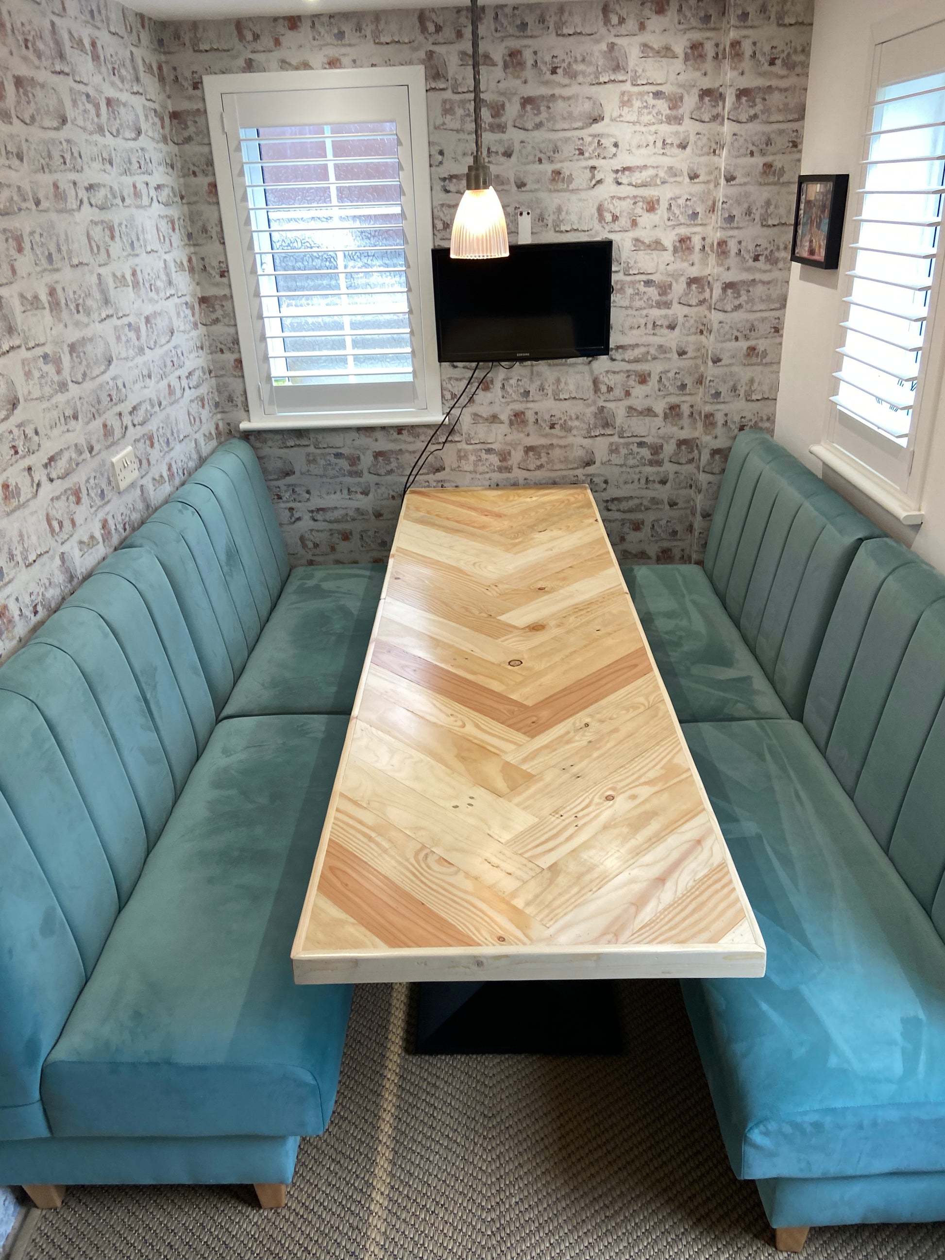 Handmade herringbone dining table with matching reclaimed wood benches