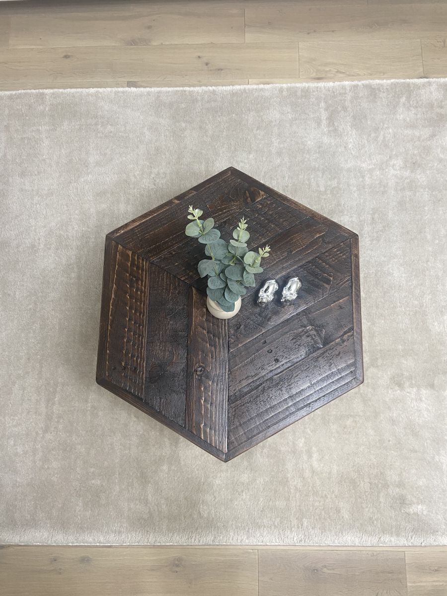 Hexagonal reclaimed wood coffee table with raw steel hairpin legs, rustic handcrafted design with eco-friendly wax finish