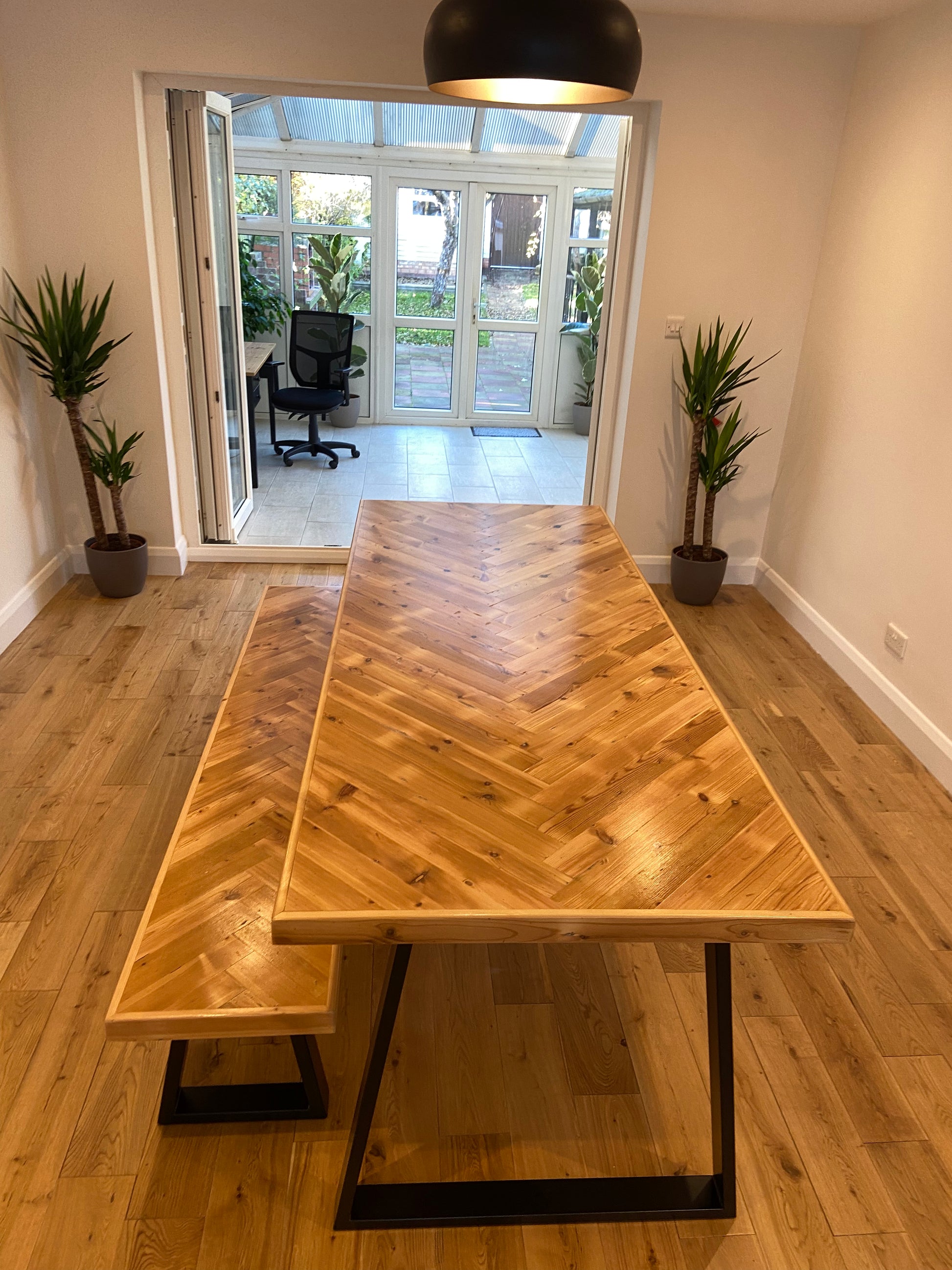 Handmade herringbone table crafted from reclaimed wood with metal legs, made to order in the UK