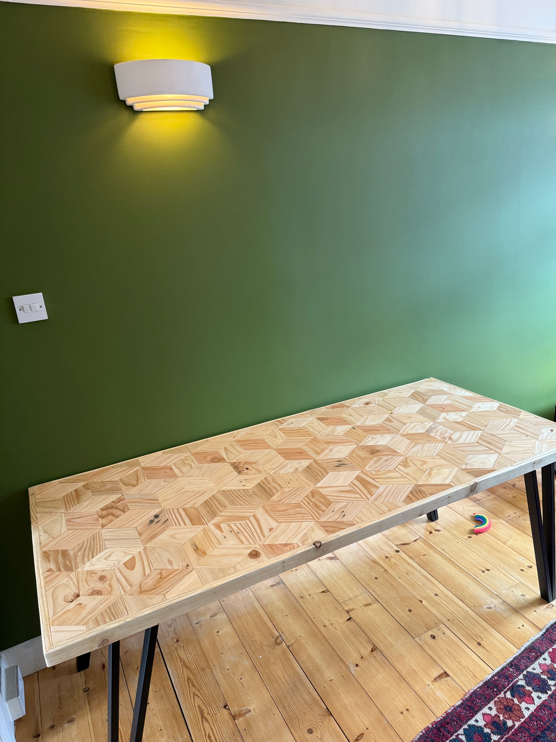 Handcrafted 3D reclaimed wood dining table with unique random pattern top, natural wax finish, and rustic character details like saw marks and paint traces