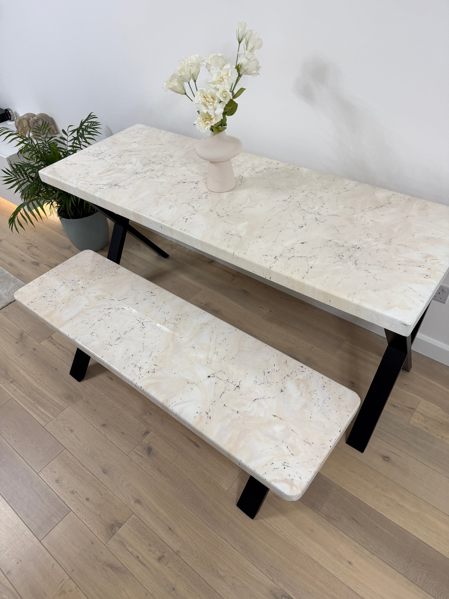 Handmade epoxy resin dining table with artistic marble effect top and custom metal legs – made to order in the UK, optional matching benches available.