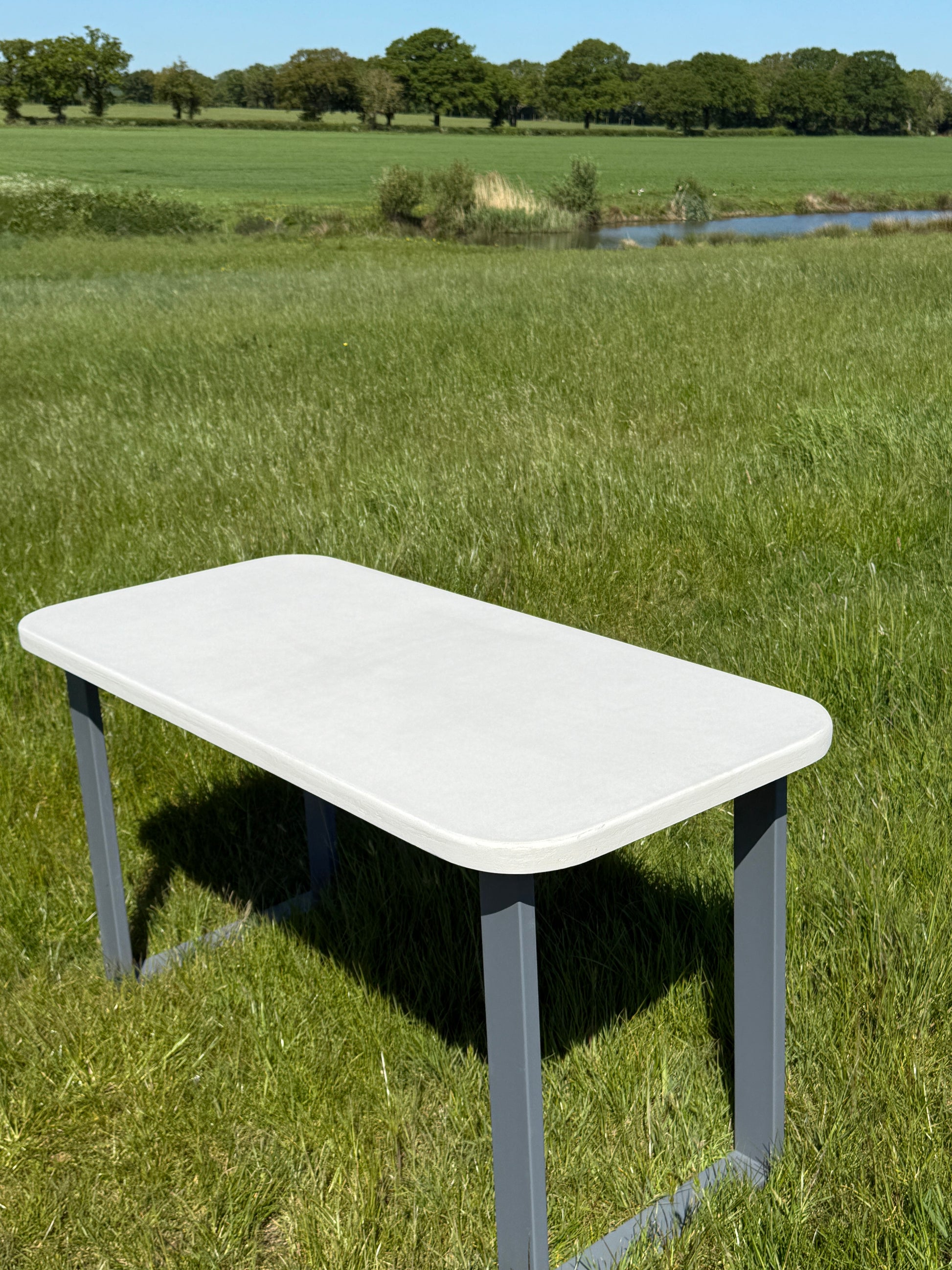 Handmade outdoor microcement dining table with white concrete-style top and matching benches – made to order in the UK, ideal for patios and terraces.