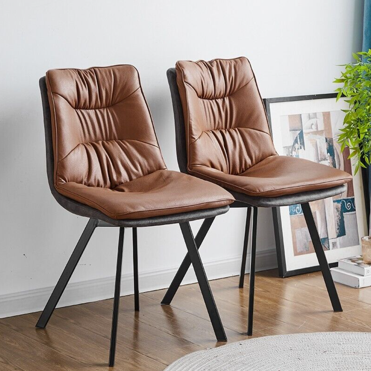 Set of 2 faux leather dining chairs with metallic frame and padded seat – modern indoor design