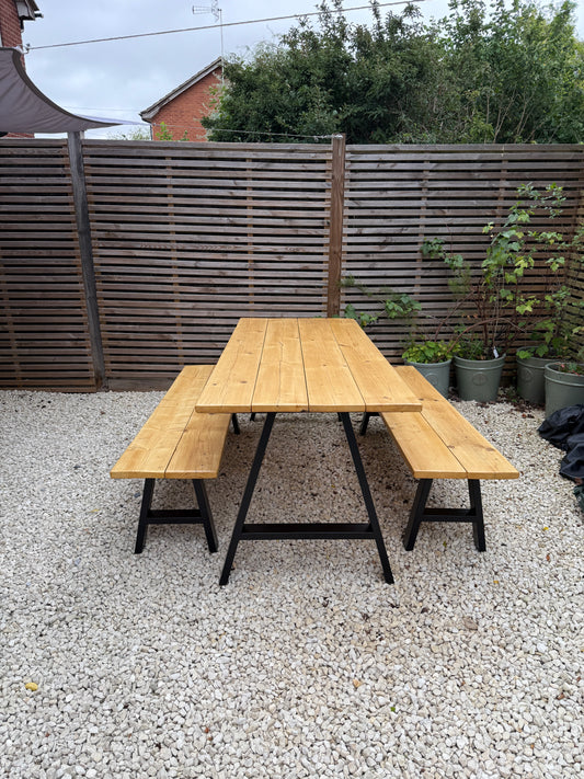 Handcrafted outdoor dining table made from reclaimed scaffold boards
