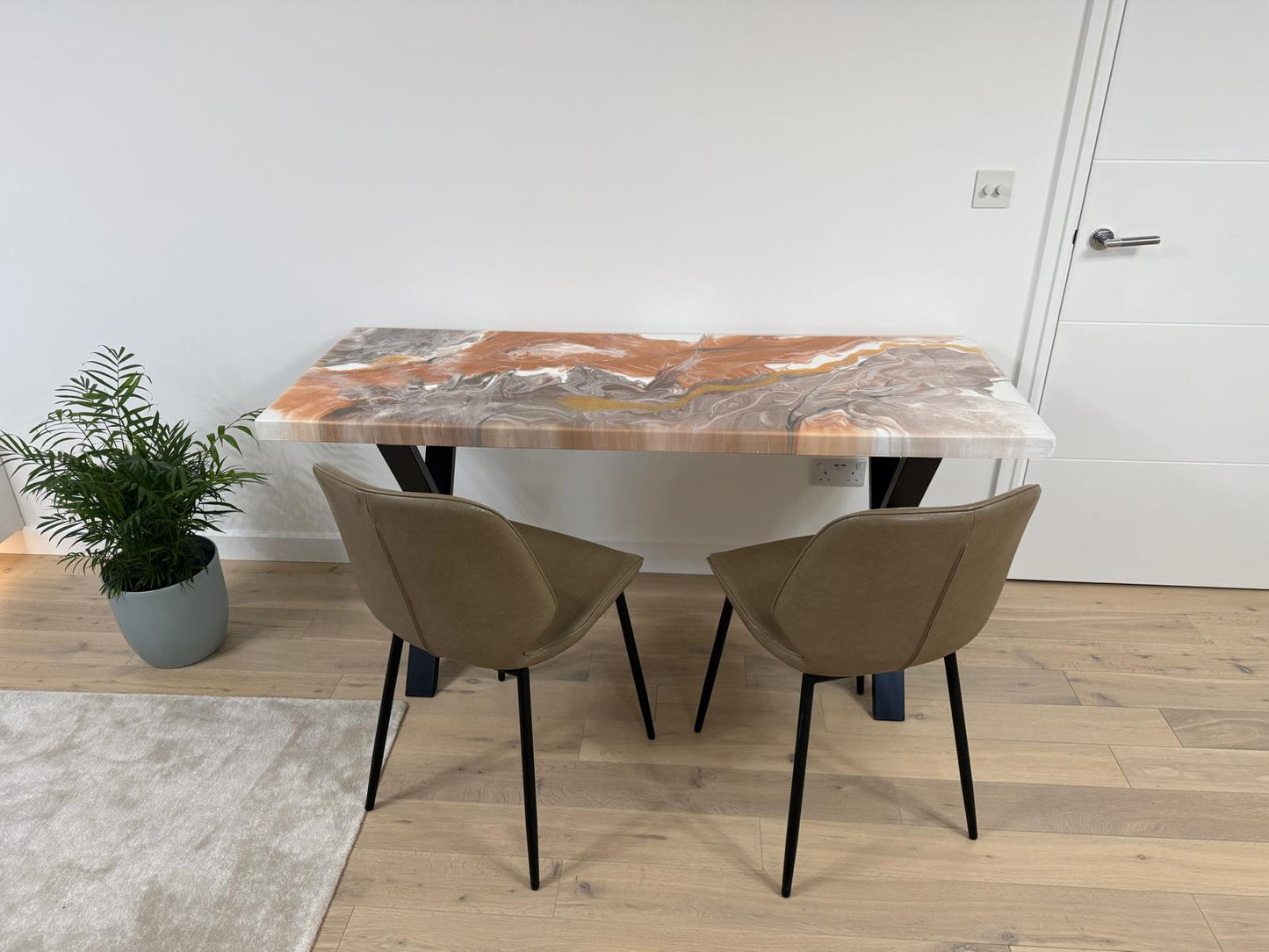 Handmade epoxy resin dining table with colourful pouring art design and custom metal legs – made to order in the UK.