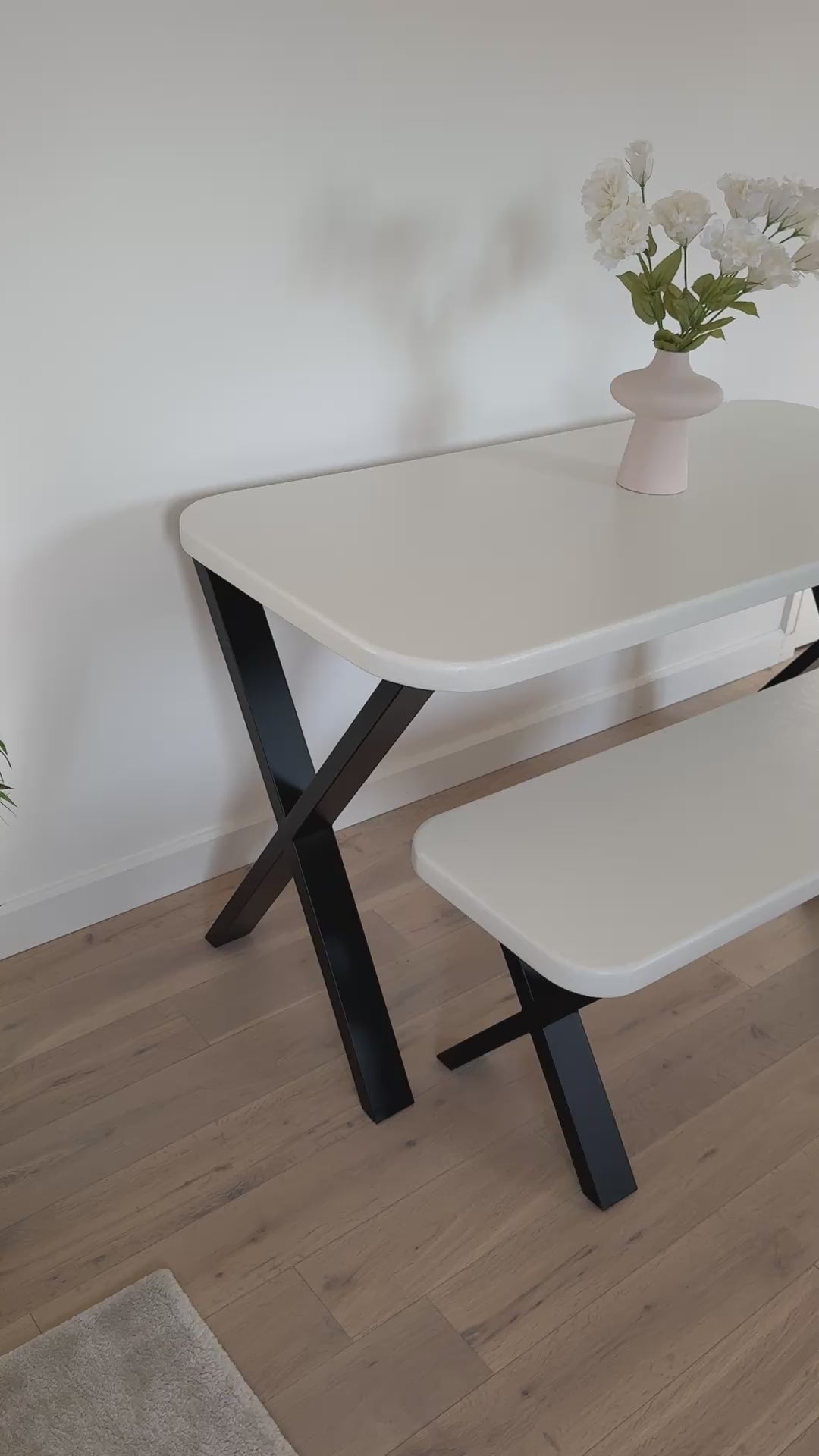 Handmade microcement dining table with white concrete-style top and matching benches, black metal legs – made to order in the UK.