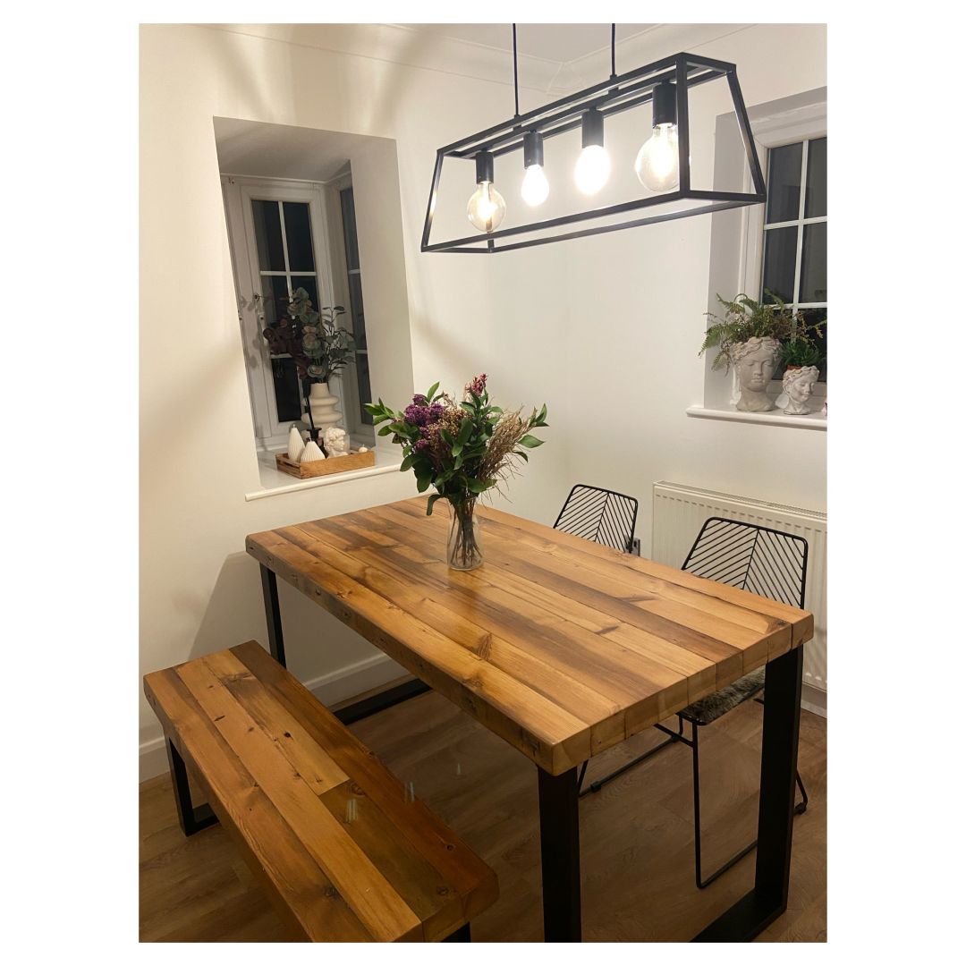 Reclaimed wood dining table with matching benches tucked underneath – rustic industrial style furniture set
