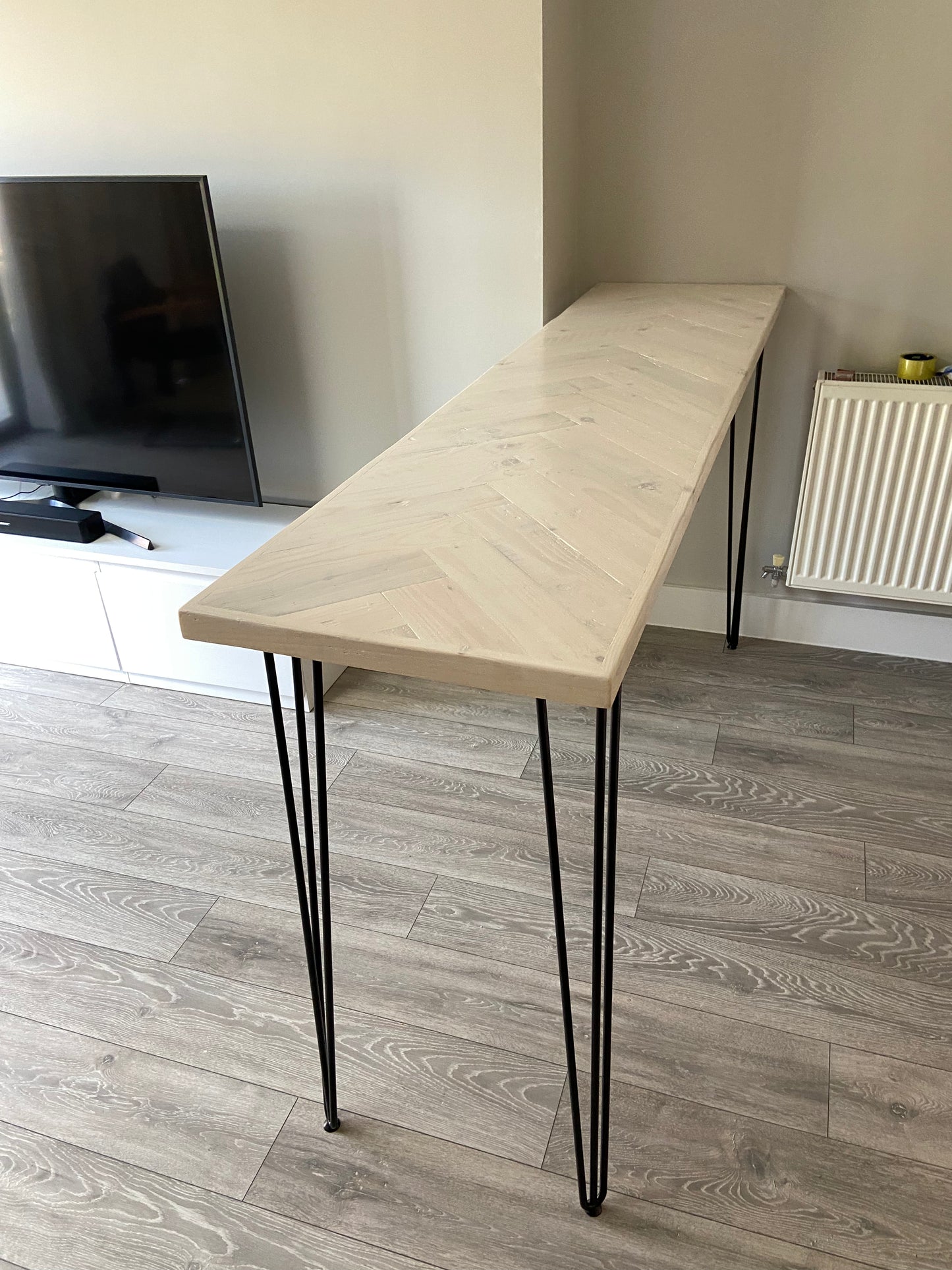 Handmade herringbone breakfast bar crafted from reclaimed wood with custom metal legs, made to order in the UK