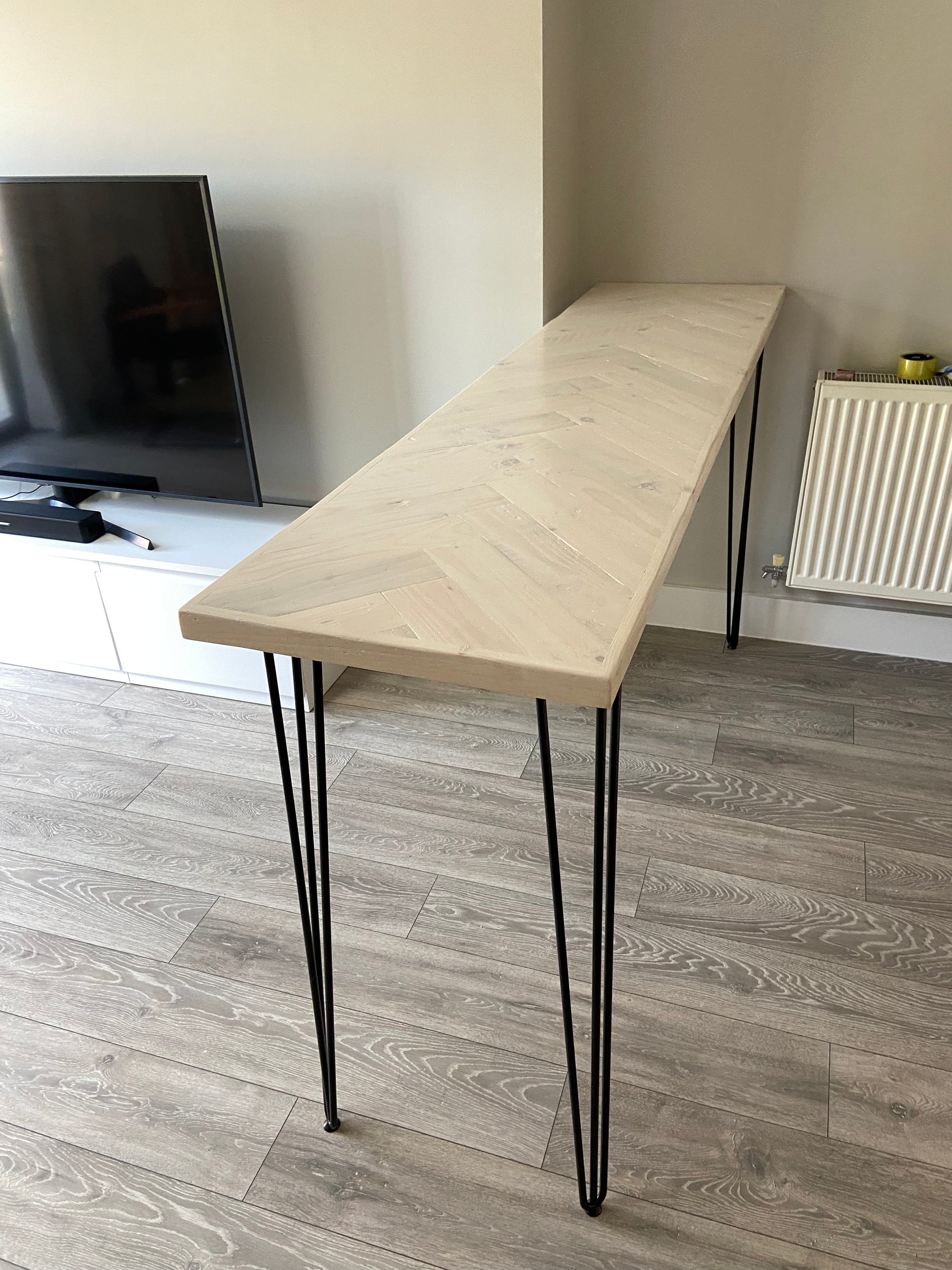 Handmade herringbone breakfast bar crafted from reclaimed wood with custom metal legs, made to order in the UK