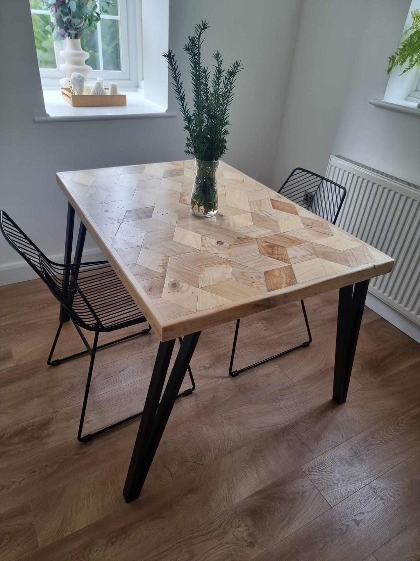 Handcrafted 3D reclaimed wood dining table with unique random pattern top, natural wax finish, and rustic character details like saw marks and paint traces