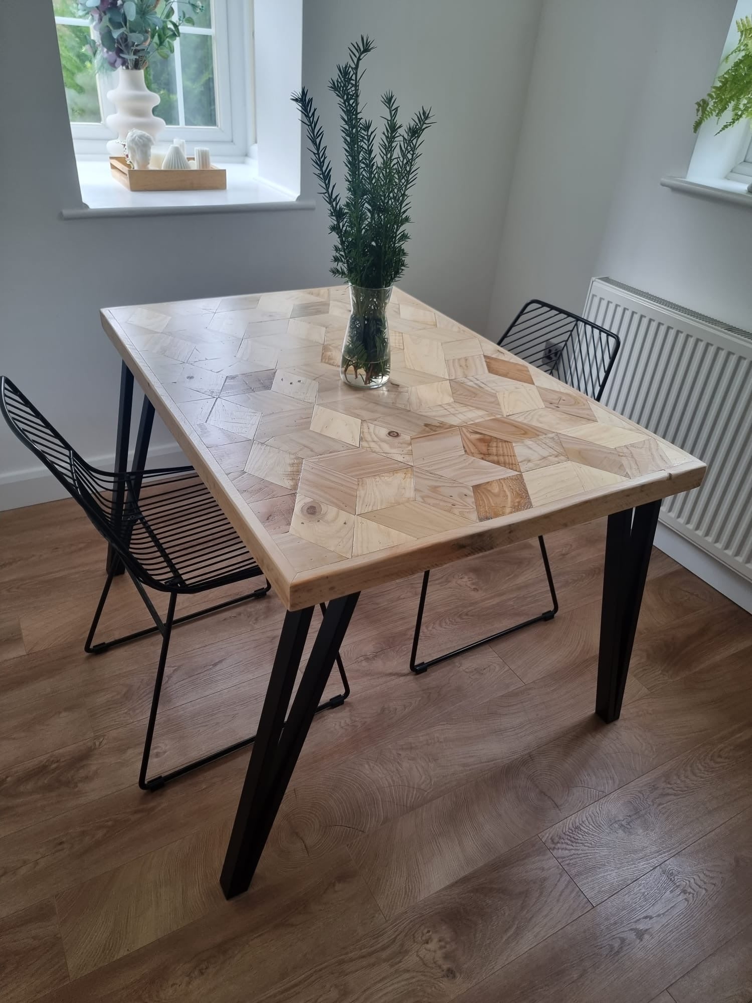 Handcrafted 3D reclaimed wood dining table with unique random pattern top, natural wax finish, and rustic character details like saw marks and paint traces
