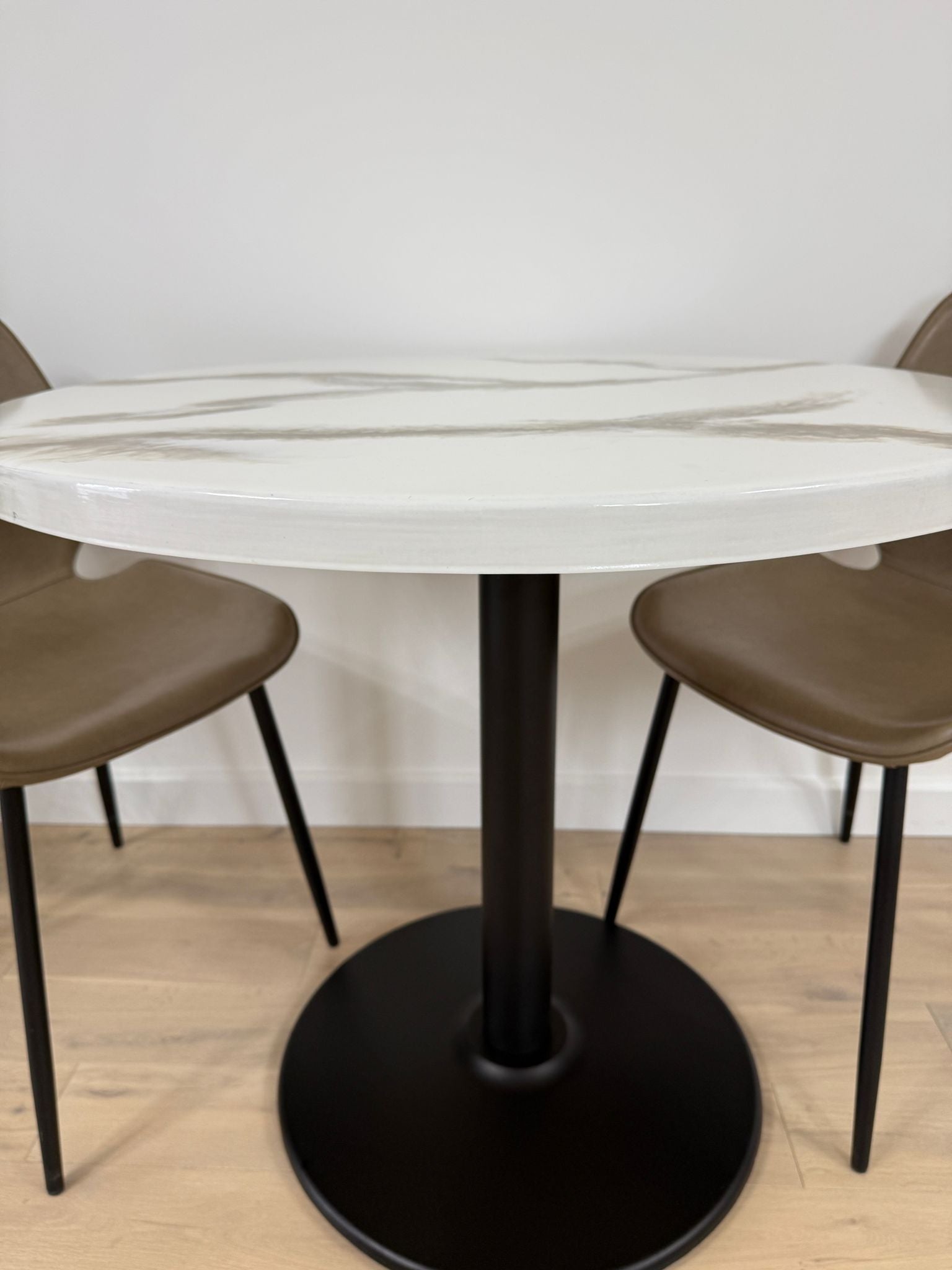 Handmade round epoxy resin dining table with 3.6 cm thick top and cast iron pedestal base – made to order in the UK.